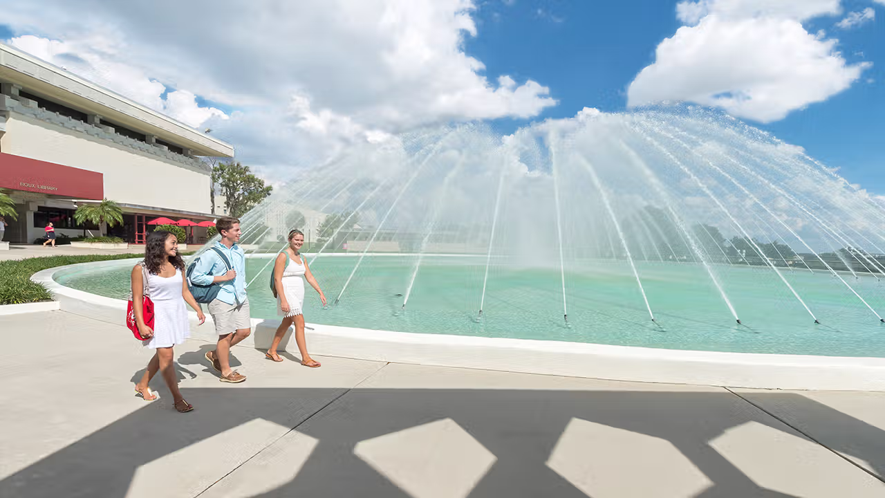 Student walking near the Frank Lloyd Wright-designed Water Dome.