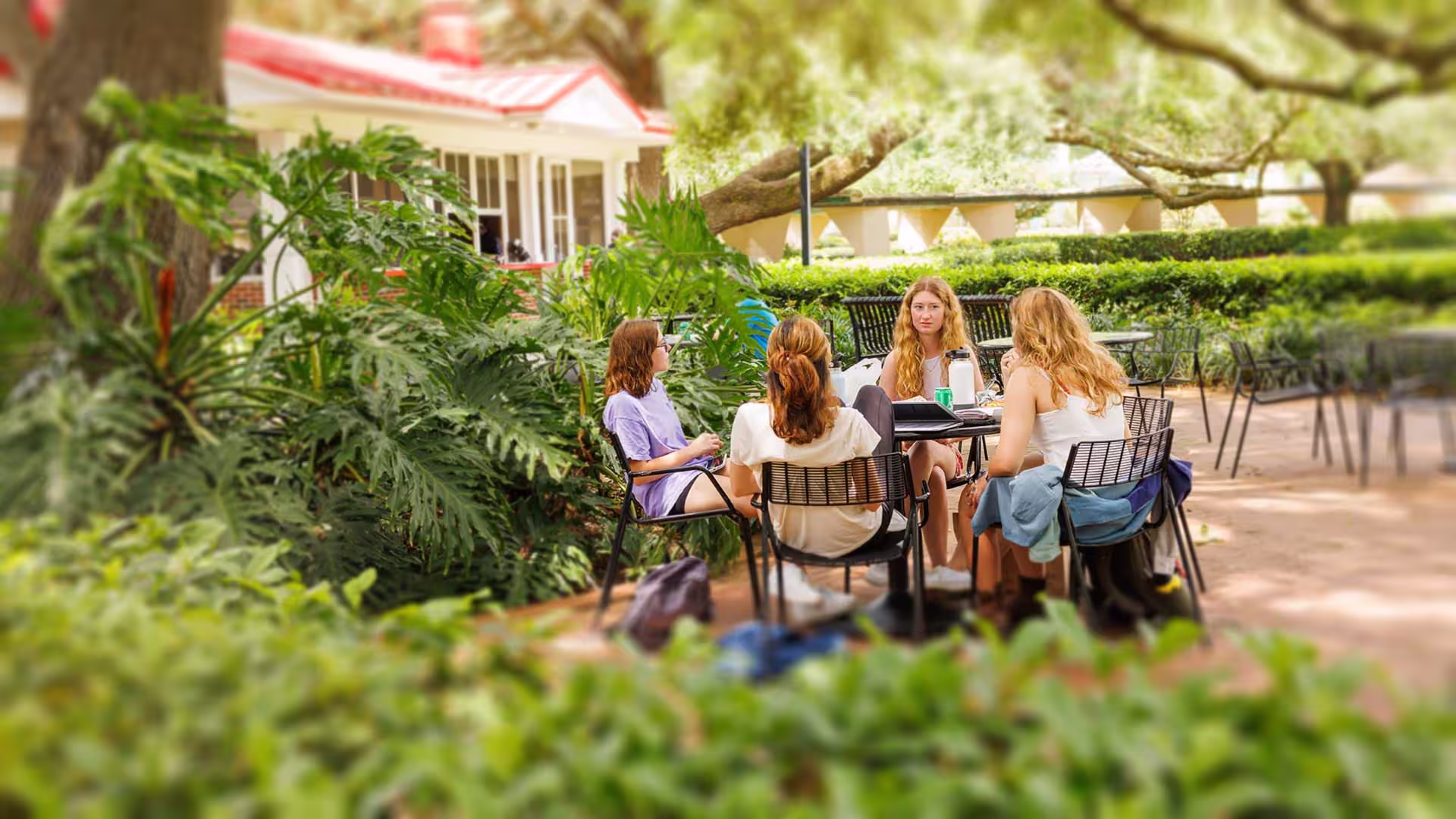 Students sitting outside at table 