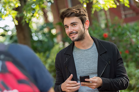student holding phone
