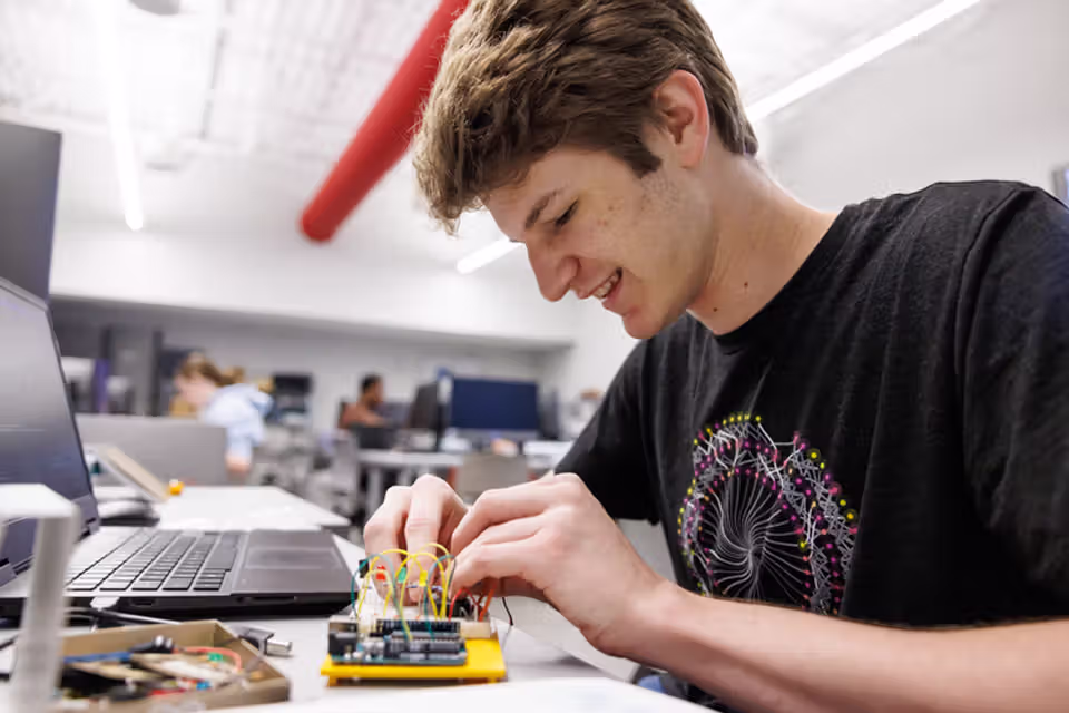 student working on bread board
