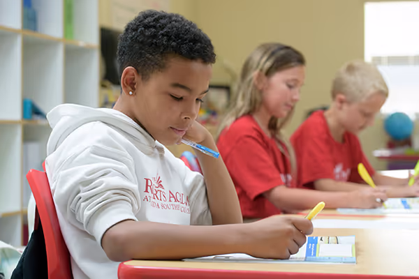 Children writing in classroom