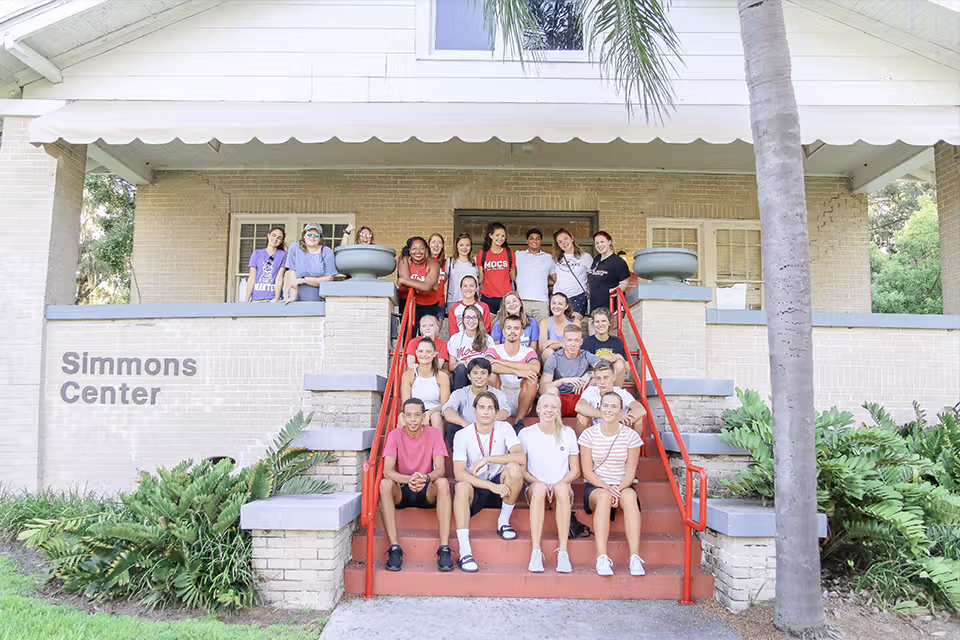 Students sitting on the steps if Simmons Multicultural Center