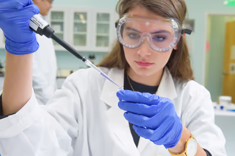 lab student using a pipet