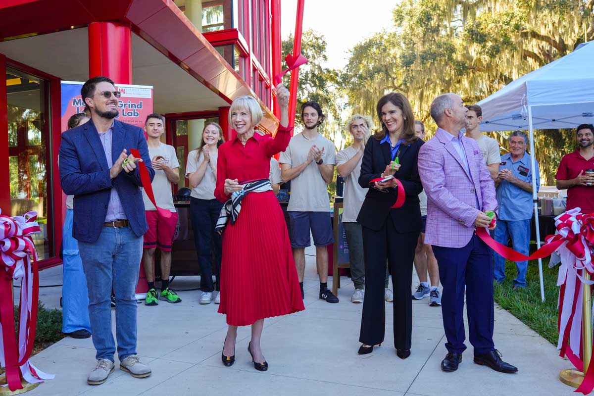 Kerr holding up the cut ribbon