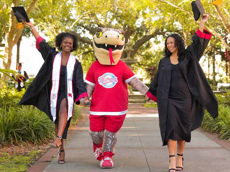 graduates walk with Mocsie