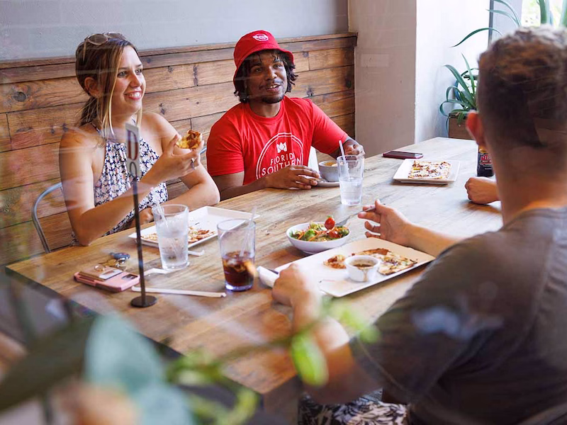 Three students eating a meal at a local Lakeland restaurant