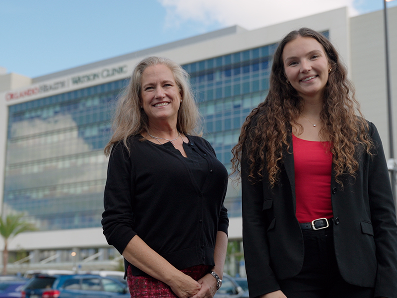 Kim Downs (left) and Morgan Word (right) stand smiling outside of Watson Clinic.